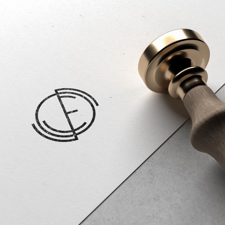 A stamped logo with circular initials design.