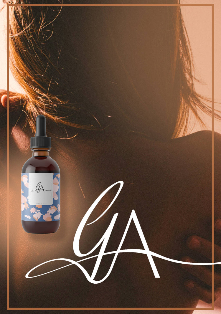 Product image featuring a bottle with a 'GA' logo in front of a blurred background of a person's back, with the 'GA' logo in large handwritten script.